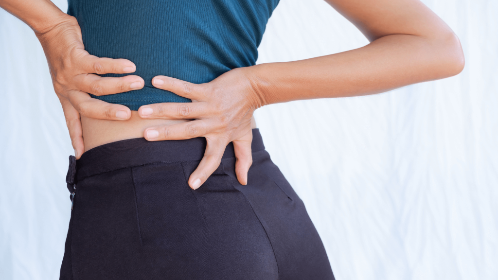 Woman holding her back with back pain