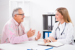 What Are The Signs of a Stroke - Doctor sits with patient