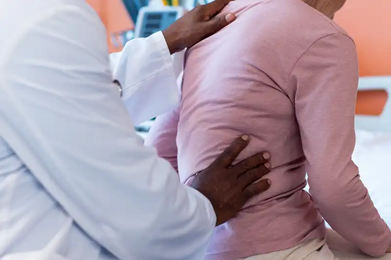 midsection of diverse senior male doctor examining