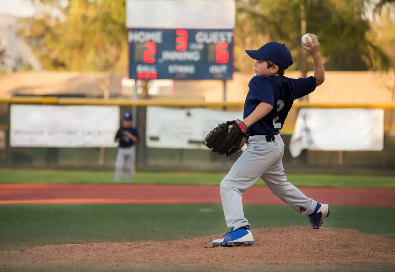 boy-without-common-baseball-injuries-pitching-during-baseball-game